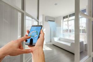 smart house, home automation, device with app icons. Man uses his smartphone with smarthome security app to unlock the door of his house. photo