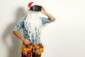 Santa Claus wearing virtual reality goggles, on a white background. Christmas photo