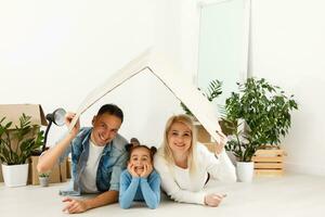 Family unpacking cardboard boxes at new home photo