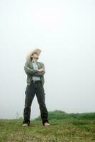 Cowboy Delight - Man in Mexican Hat and Boots amid Foggy Landscape photo