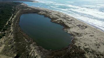 Marina di Vecchiano Pisa Tuscany Italy aerial view of the small lake in front of the sea video