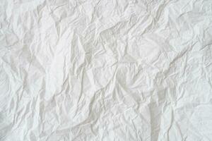 Wrinkled or crumpled white stencil paper or tissue after use in toilet or restroom with large copy space used for background texture in decorative art work photo