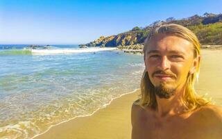 selfie con rocas acantilados ver olas playa puerto escondido México. foto