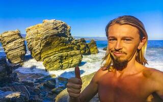 Selfie with rocks cliffs view waves beach Puerto Escondido Mexico. photo