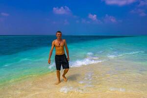 Male model tourist on island Madivaru Finolhu Rasdhoo Atoll Maldives. photo