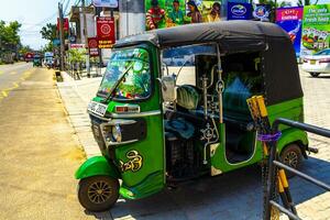 Mirissa Beach Southern District Sri Lanka 2018 Green decorated adorned Tuk Tuk Rickshaw Mirissa Beach Sri Lanka. photo