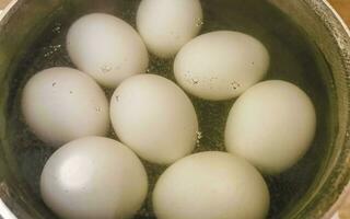 Boil eggs hard or soft in black pot in Mexico. photo