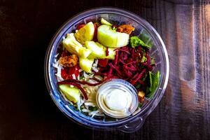 Salad with beet cucumber chicken tomatoes onions and limes in Mexico. photo