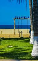 Romantic paradise swing on the beach in Puerto Escondido Mexico. photo