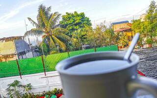 Cup of americano black coffee in tropical restaurant Mexico. photo