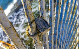 Lock on metal railing on beach Playa del Carmen Mexico. photo