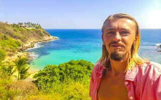 Selfie rocks cliffs view waves Carrizalillo beach Puerto Escondido Mexico. photo