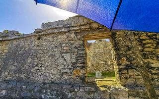 Ancient Tulum ruins Mayan site temple pyramids artifacts landscape Mexico. photo