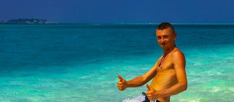 Male model tourist on island Madivaru Finolhu Rasdhoo Atoll Maldives. photo