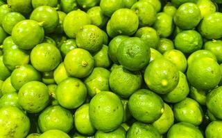 Juicy green lime lemon citrus fruit fruits supermarket Mexico. photo