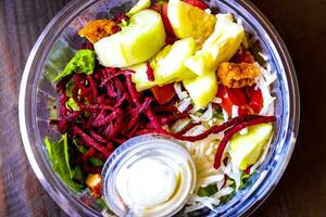 Salad with beet cucumber chicken tomatoes onions and limes in Mexico. photo