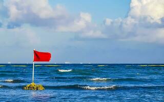 Red flag swimming prohibited high waves Playa del Carmen Mexico. photo