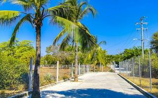 Typical beautiful colorful tourist street sidewalk city Puerto Escondido Mexico. photo