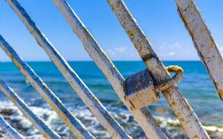 Lock on metal railing on beach Playa del Carmen Mexico. photo