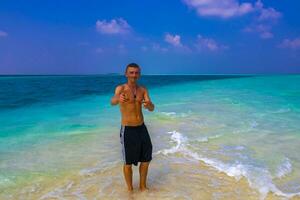 Male model tourist on island Madivaru Finolhu Rasdhoo Atoll Maldives. photo