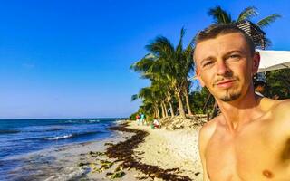 Male tourist Travelling man taking selfie Playa del Carmen Mexico. photo