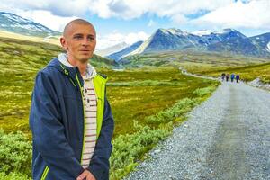 Young hiker and mountains landscape panorama Rondane National Park Norway. photo