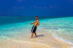 Male model tourist on island Madivaru Finolhu Rasdhoo Atoll Maldives. photo