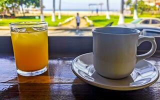 Cup of americano black coffee and orange juice restaurant Mexico. photo