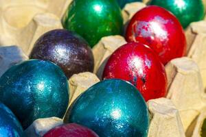 Colorful Easter eggs in egg shell in hands in Netherlands. photo