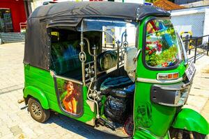 Mirissa Beach Southern District Sri Lanka 2018 Green decorated adorned Tuk Tuk Rickshaw Mirissa Beach Sri Lanka. photo