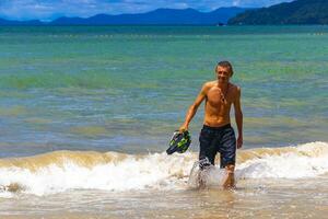 Male handsome tourist swimming having fun Railay West Beach Thailand. photo