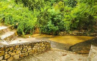 Open sewerage system in the tropical jungle mountains Mexico. photo