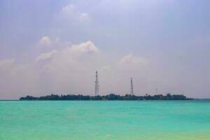 Rasdhoo island view from tropical sandbank islands Madivaru Finolhu Maldives. photo