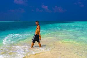 Male model tourist on island Madivaru Finolhu Rasdhoo Atoll Maldives. photo