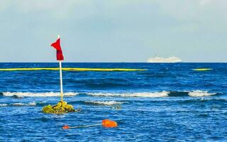 Red flag swimming prohibited high waves Playa del Carmen Mexico. photo