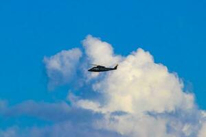 Tourist helicopter flies over the Caribbean Sea in Mexico. photo