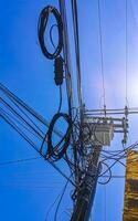 Absolute cable chaos on mexican power pole in Mexico. photo