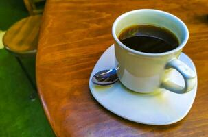 Cup of americano black coffee in restaurant Mexico. photo