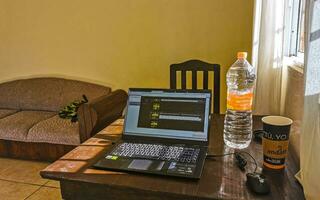 Playa del Carmen Quintana Roo Mexico 2021 Laptop work at table with coffee cup in Mexico. photo