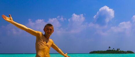 Male model tourist on island Madivaru Finolhu Rasdhoo Atoll Maldives. photo