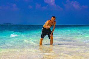 Male model tourist on island Madivaru Finolhu Rasdhoo Atoll Maldives. photo