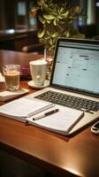 Desk with notepad and pen next to keyboard photo