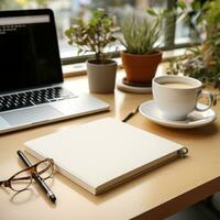 Desk with notepad and pen next to keyboard photo