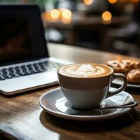 Coffee and laptop on desk photo