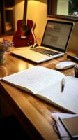 Desk with notepad and pen next to keyboard photo