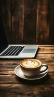 Coffee and laptop on a wooden table photo