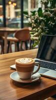 Coffee and laptop on desk photo