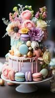 Pastel rainbow cake with macarons and flowers photo