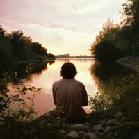 Woman admiring river sunset photo