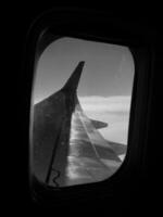 Beautiful view from airplane window, large wing of aircraft shows casement photo